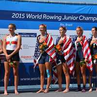 <p>Kaitlyn Kynast, second from right on the U.S. team, listens to the national anthem with her teammates.</p>