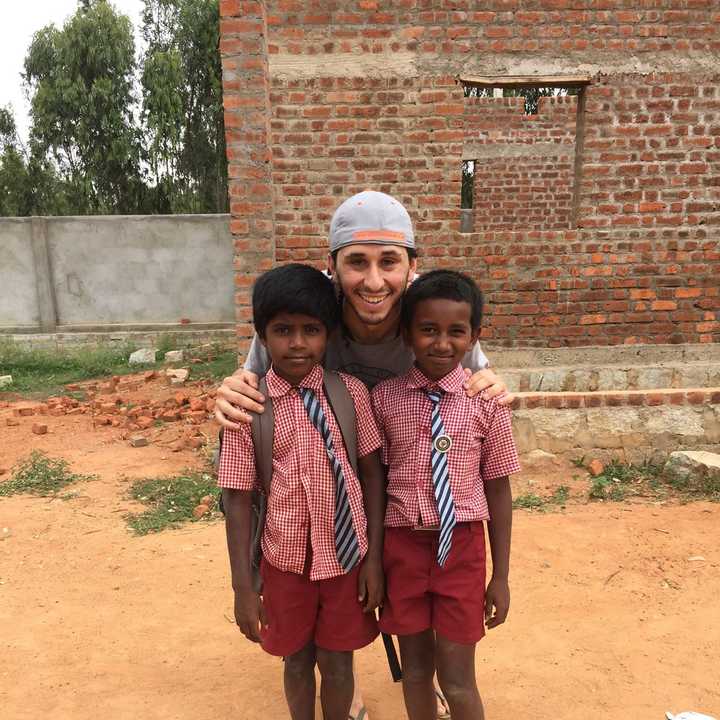 Kiefer Kofman and two children during a village trip, where he was able to play with students at the local school.
