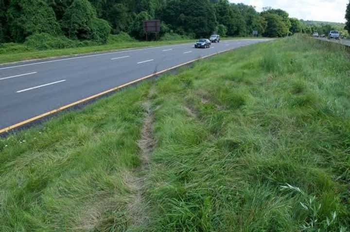 A look at the  tire marks and tracks in the northbound lane where the BMW SUV exited  into the center median, struck an earth embankment, and became airborne into the southbound lanes.