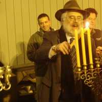 <p>Rabbi Yehoshua Hecht of Beth Israel of Westport and Norwalk continues lighting the menorah.</p>