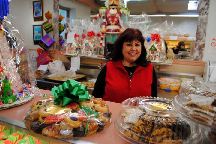 Rose Sanca, owner of Homestyle Desserts Bakery, stands behind the counter of the retail side of her Cortlandt bakery. 