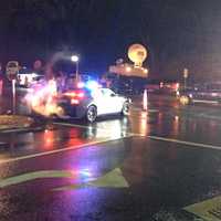 <p>Police direct traffic and television trucks line the streets around the entrance to Newtown High School.</p>