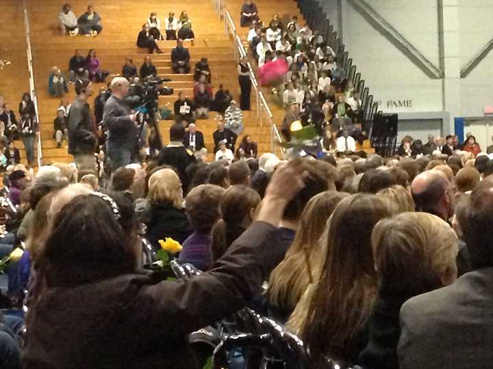 An audience member waves a single rose during &quot;A Tribute to Newtown, Connecticut&quot; in Danbury Wednesday.