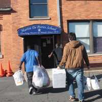 <p>German School students deliver toys and clothes to students at Martin De Porres School in Elmont, N.Y., on the Nassau County border with Queens.</p>