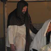 <p>Volunteer actors dressed as Joseph and Mary cradle a facsimile of a newborn Jesus inside the stable at Eastchester Community Church.</p>
