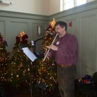 <p>Clint Goss played holiday songs on the flute at the Christmas Day feast in Westport.</p>