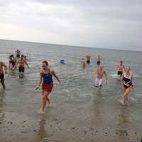 <p>Polar bear swimmers Tuesday during the Team Mossman Polar Plunge at Compo Beach in Westport to benefit Save the Children.</p>