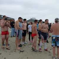 <p>Swimmers preparing to take the plunge at Compo Beach Tuesday at the Team Mossman Polar Plunge to benefit Save the Children.</p>