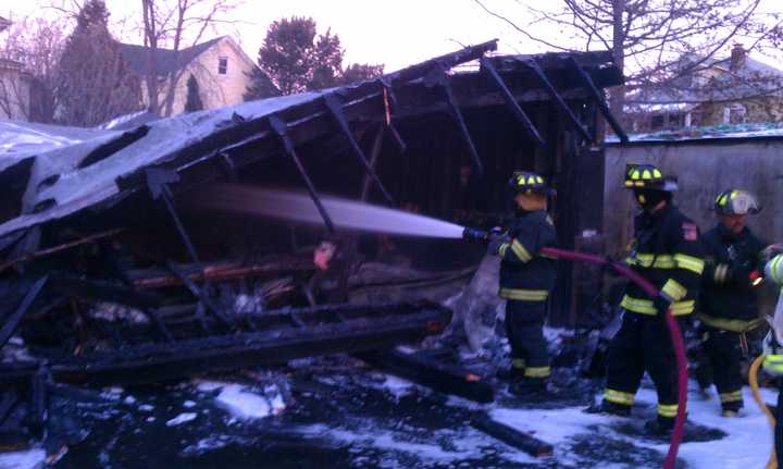 Ossining firefighters battled a fire on North Malcolm Street on Wednesday afternoon. No one was injured, but a nearby van and the garage were destroyed.