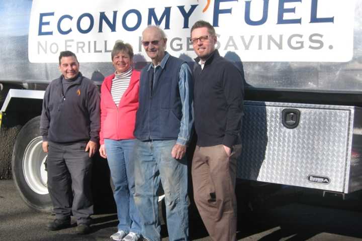 From left, fuel deliveryman David Kycia, Bonnie Lindsay, Sgt. Glenn Benton and Economy Fuel Managing Director Mike Gill pose after Benton learned he was a &quot;Heat for Heroes&quot; winner at his Fairfield home.