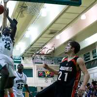 <p>Norwalk&#x27;s Roy Kane goes in for a shot as Ridgefield&#x27;s Jon Hicks looks on.</p>