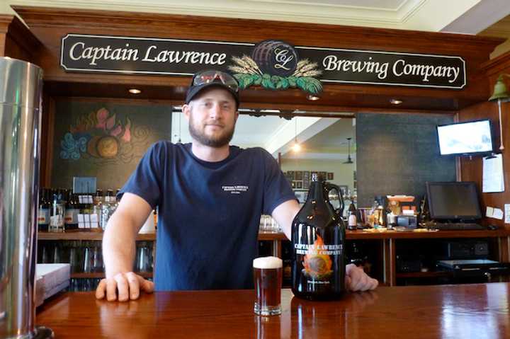 Ryan Kipp, a brewer at Captain Lawrence Brewing Company, stands with a sample of his new beer called &quot;The Pride of Elmsford.&quot;