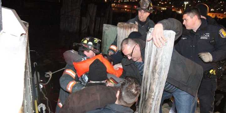 Emergency service personnel take one of the victims off a rescue boat Sunday evening  after a plane crashed in the Hudson River. 