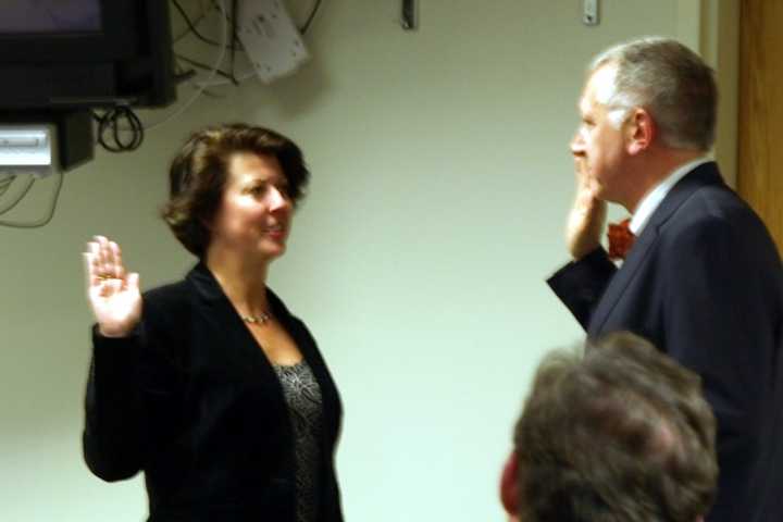 Fairfield Town Clerk Betsy Browne swears in new Representative Town Meeting Member Joseph &quot;Jay&quot; Lipp Monday night. 