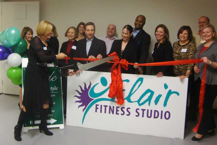 Amy Shelton, owner of Darien&#x27;s Flair Fitness Studio, cuts the ribbon on the new location.