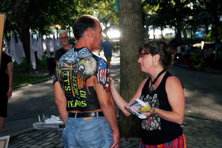 Somers artist Jennifer Siciliano paints a 9/11 first responder at a Ground Zero 10th anniversary event.