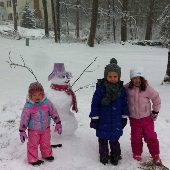 Sisters Eliana and Madelyn Soccio, 5 and 2 respectively, built a snowman along with friend Riley Stewart, 5, outside the Soccio residence on Arrowhead Trail. 