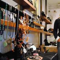 <p>Jennifer Rutheny stands by some of the work of invited jewelers, in her shop. </p>