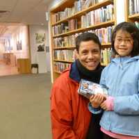 <p>Jujiang Metcalf, right, 8, and her mom Suzanne, of Norwalk, drop in at New Canaan Library to get some books and videos. The youngster says she&#x27;s happy to be on a school break this week. </p>