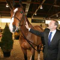 <p>Westchester County Executive Rob Astorino pets Campino, a 13-year-old Dutch warmblood, at North Salem&#x27;s Old Salem Farm.</p>