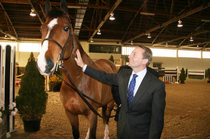 Westchester County Executive Rob Astorino pets Campino, a 13-year-old Dutch warmblood, at North Salem&#x27;s Old Salem Farm.