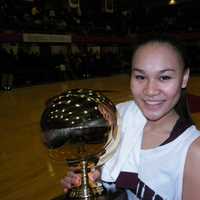 <p>Ossining senior and captain Danielle Gervacio holds the gold ball after the Pride defeated Our Lady of Lourdes, 83-51 Sunday for their third consecutive Section 1 Class AA championship.</p>