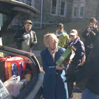 <p>Kat Klein (left) hands Jared Roman (right) a bag of pet food to donate to the Hudson Valley Pet Food Pantry on Tuesday. </p>