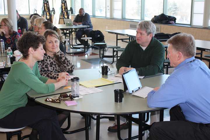 Peekskill Superintendent of Schools James Willis, right, talks with residents at a budget forum last weekend at Peekskill Middle School.