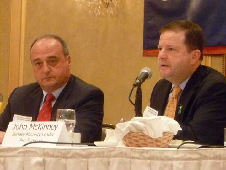 State Sen. John McKinney , R., explains how he wants the state to help small businesses as much as big ones as State Rep. Lawrence Cafero, R., listens during a Business Council of Fairfield County meeting Tuesday. 