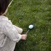 <p>A young girl gets ready to roll her egg at the annual Easter Egg Roll on the South Lawn of the White House.</p>