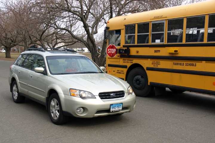 Drivers that a school bus, like the car in this demonstration in Fairfield on Monday, are subject to a fine of up to $450. 