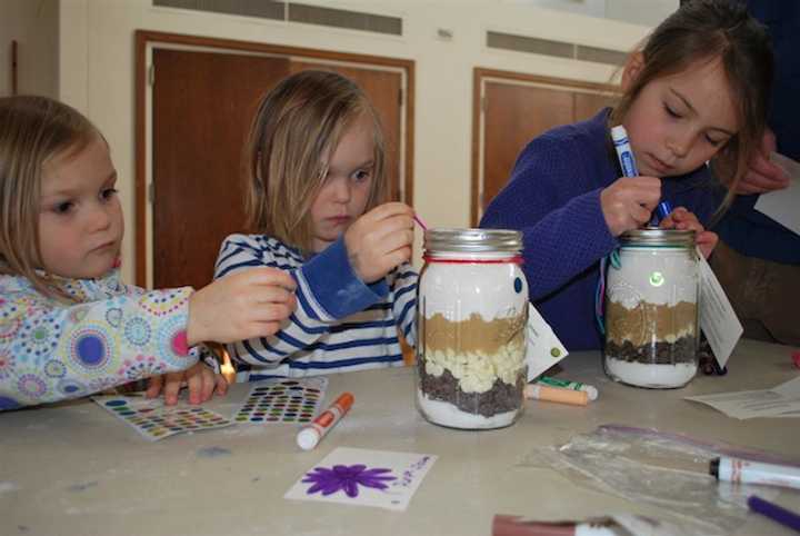 From left, Keeley Strine and Grayson Strine, of New Canaan, and Janie Walsh, of Wilton, decorate
Jars of Joy for Family and Childrens Agency as part New Canaan Country Schools Community Service
Day on March 9.