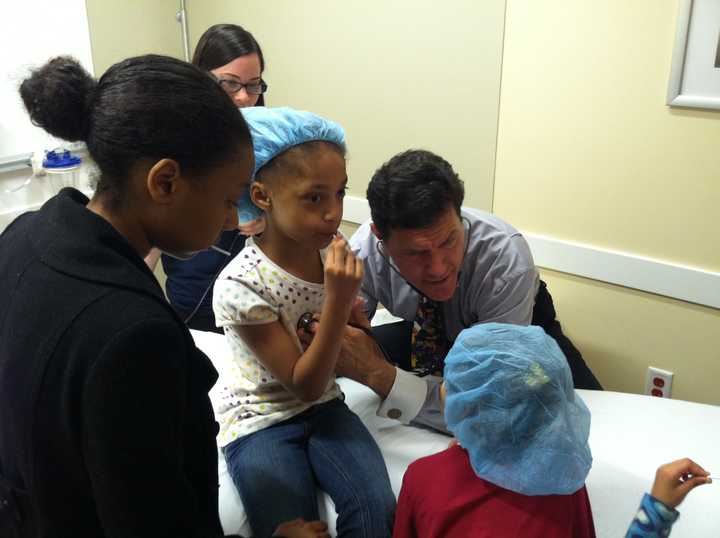 Amani Campbell from White Plains gets a check-up from Dr. Pete Richel Saturday at the Teddy Bear Clinic inside Northern Westchester Hospital in Mt. Kisco. 