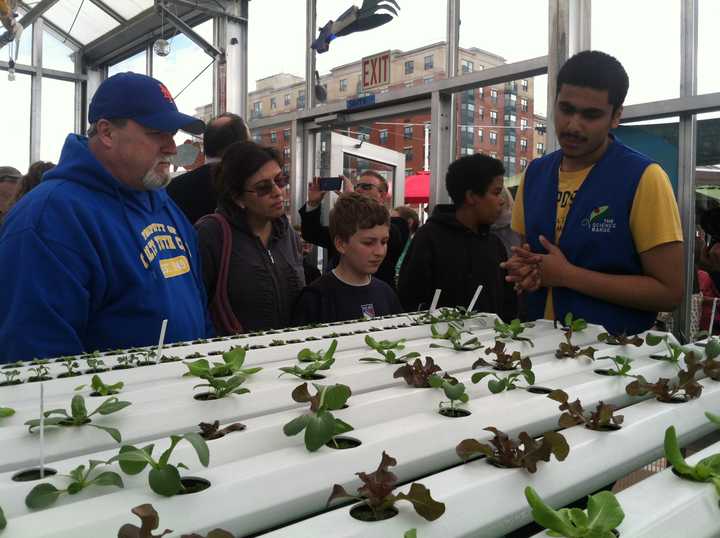 Volunteer Jaspreet Singh, 16, of Yonkers, explains various parts of the Science Barge to city residents  Fred and Lisa Brown as their 11-year-old son Andrew Saturday. 