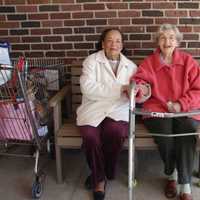 <p>Phyllis Shearer and Dorothy MacLean sit on the new Pound Ridge senior citizens bench.</p>