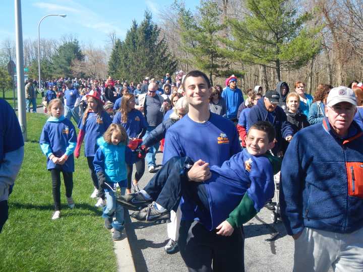 Ossining resident and Somers senior Anthony Torchia holds his cousin Nicholas Ruvo during the &quot;Go the Distance Walk&quot; to benefit the Maria Fareri Children&#x27;s Hospital.