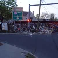 <p>A garbage truck is in the road on East Avenue at the I-95 entrance after rolling over early Thursday morning in Norwalk.</p>