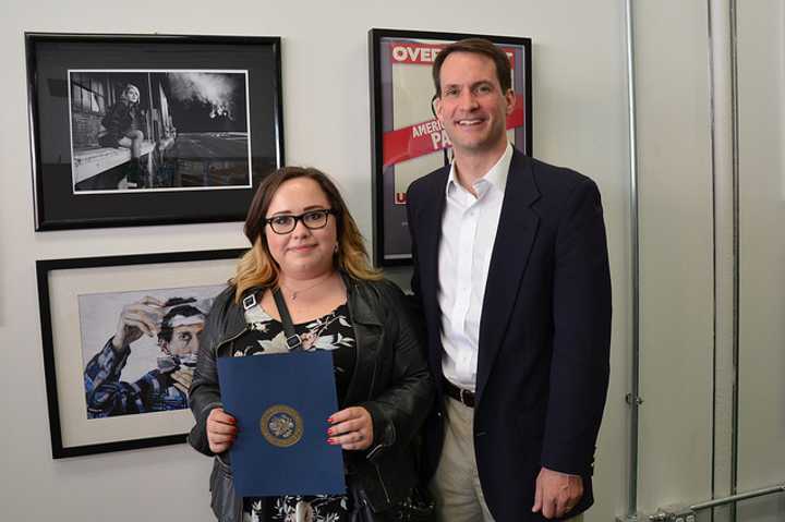 Fairfield Warde student Shannon Magnaldi poses with U.S. Rep. Jim Himes and her award-winning photo, &quot;Off-Peak.&quot;