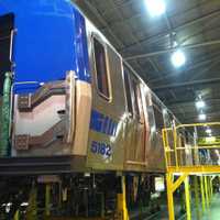 <p>A rail car under construction for the New Jersey PATH system inside the Kawasaki factory in Yonkers. </p>