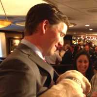 <p>Eli Manning holds a Guiding Eyes puppy. </p>