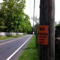 <p>No Parking signs are posted on poles on both sides of the road leading up to the Greenwich Polo Club. </p>