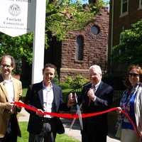 <p>From left: Pete Petron and John Miller of the Old Post Road Area Association, First Selectman Michael Tetreau and Meri Erickson of the Fairfield Museum cut the ribbon on new signs commemorating a historic district.</p>