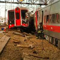 <p>A firefighter investigates the scene of the derailment on the Fairfield-Bridgeport border.</p>