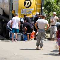 <p>Puerto Rican residents standing in line for water following Hurricane Maria last September.</p>