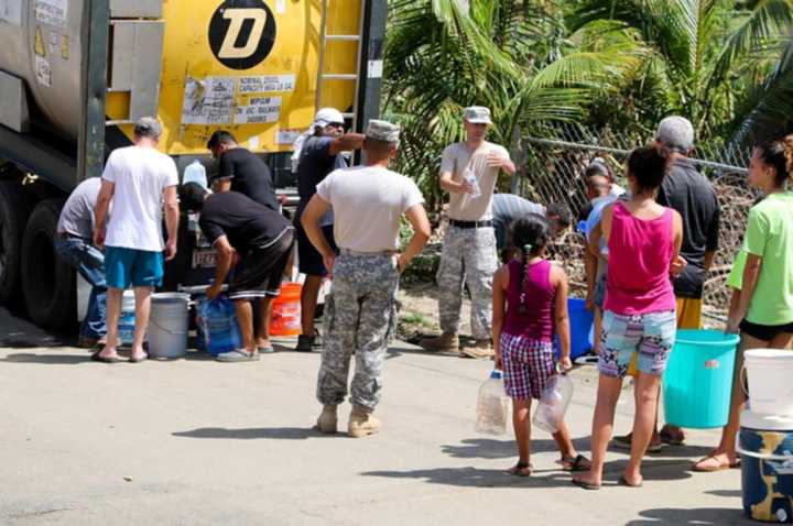 Puerto Rican residents standing in line for water following Hurricane Maria last September.