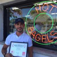 <p>Nick Batistatos, owner of Bagel Train in Suffern, accepts the DVlicious award for Best Bagels in Rockland County.</p>