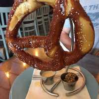 <p>Pretzel on a hook with cheese sauce.</p>