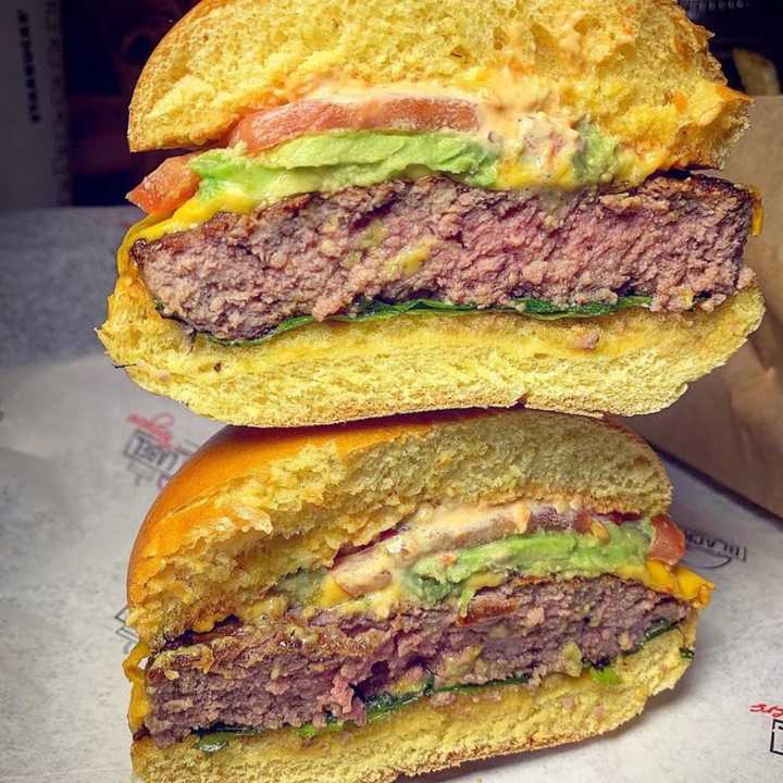 Black Label burger with American cheese, lettuce, tomato, onion and label sauce (avocado added) from Black Label Burgers, located at 683 Old Country Road in Westbury