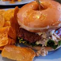 <p>Chicken sandwich on a donut.</p>