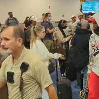 <p>Odell Beckham Jr. is escorted through Miami International Airport.</p>